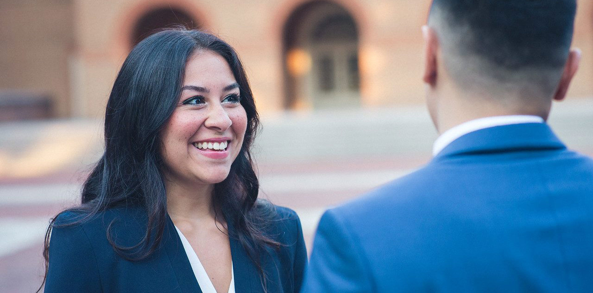 Regent University student talking to another student