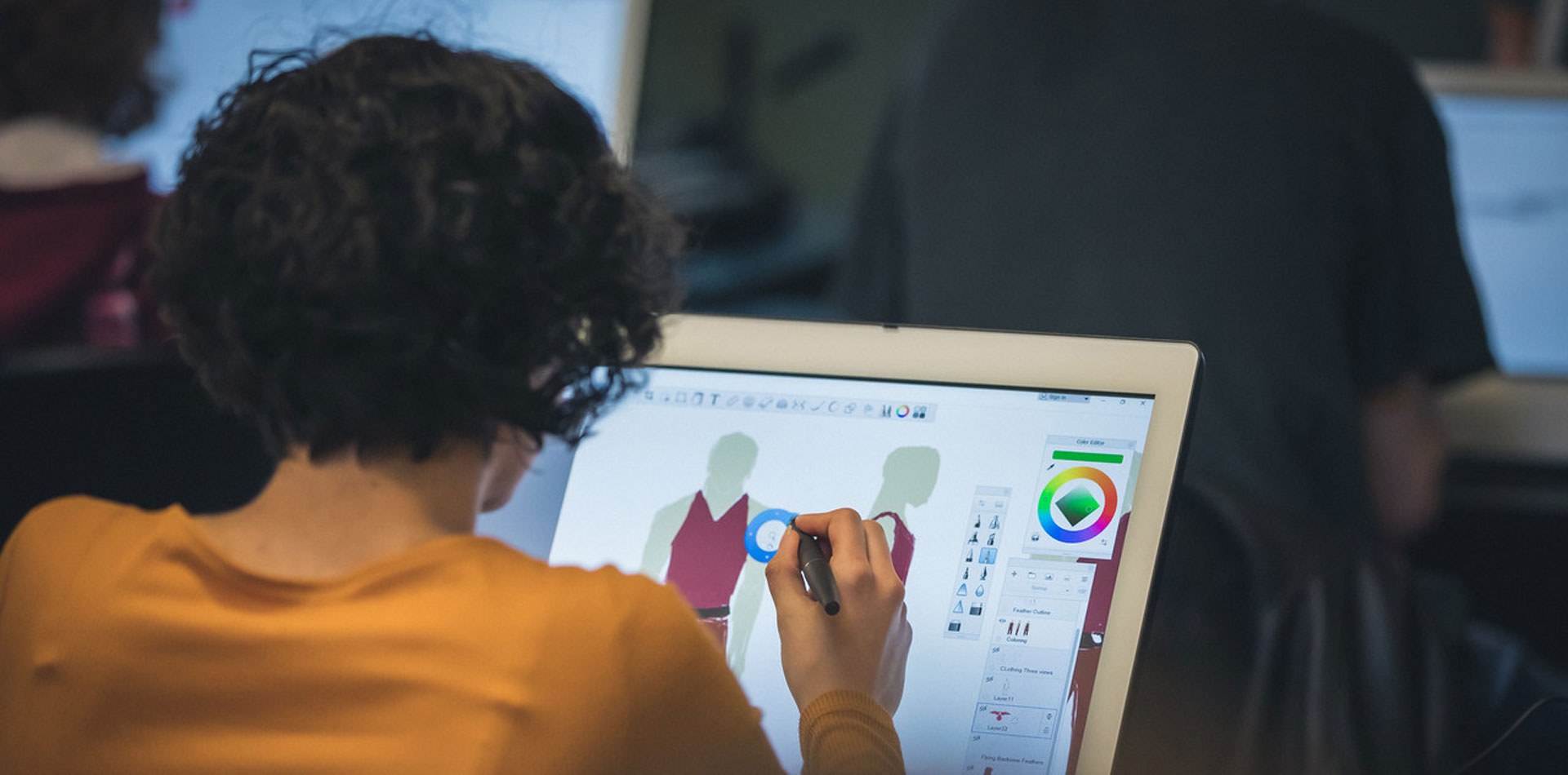 Regent University animation student drawing on a computer