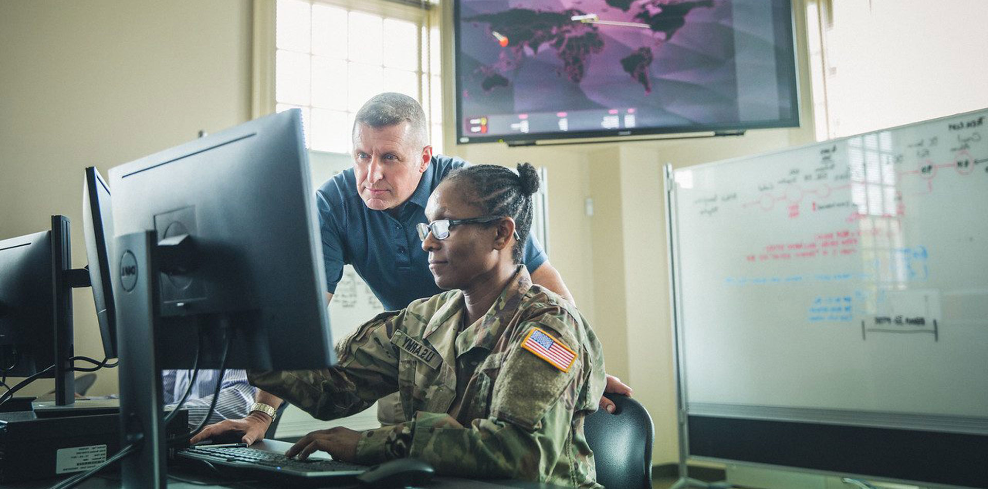 Military person looking at computers