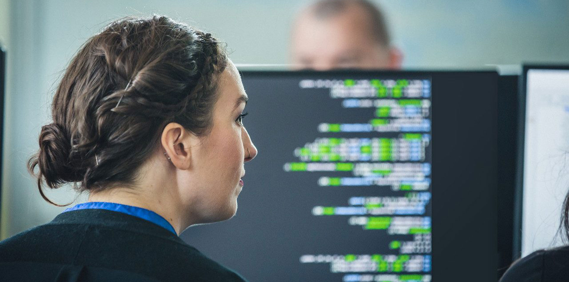 Female Regent student looking at code on a computer